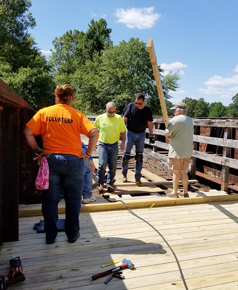 Volunteers working on decking the bridge over Canoe Creek in Roston